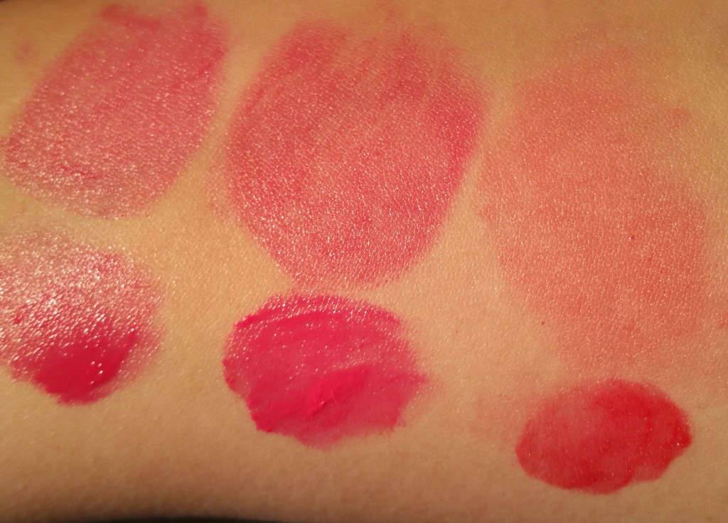 Left to right: Bobbi Brown Nourishing Lip Color in Bright Raspberry, Cosmic Peony, and Poppy - swatched on arm with natural light