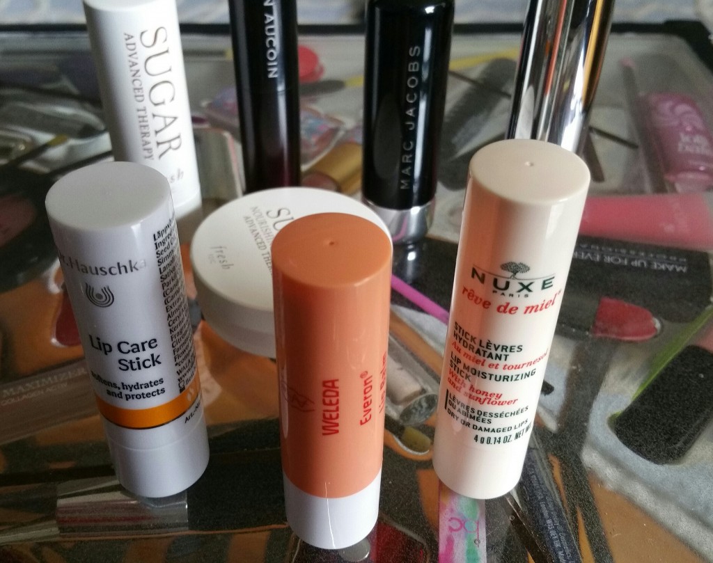 Left to right: Weleda Everon Lip Balm, Dr. Hauschka Lip Care Stick, and Nuxe Reve de Miel Lip Moisturizing Stick; Back and middle: Balms reviewed in Parts 1 and 2