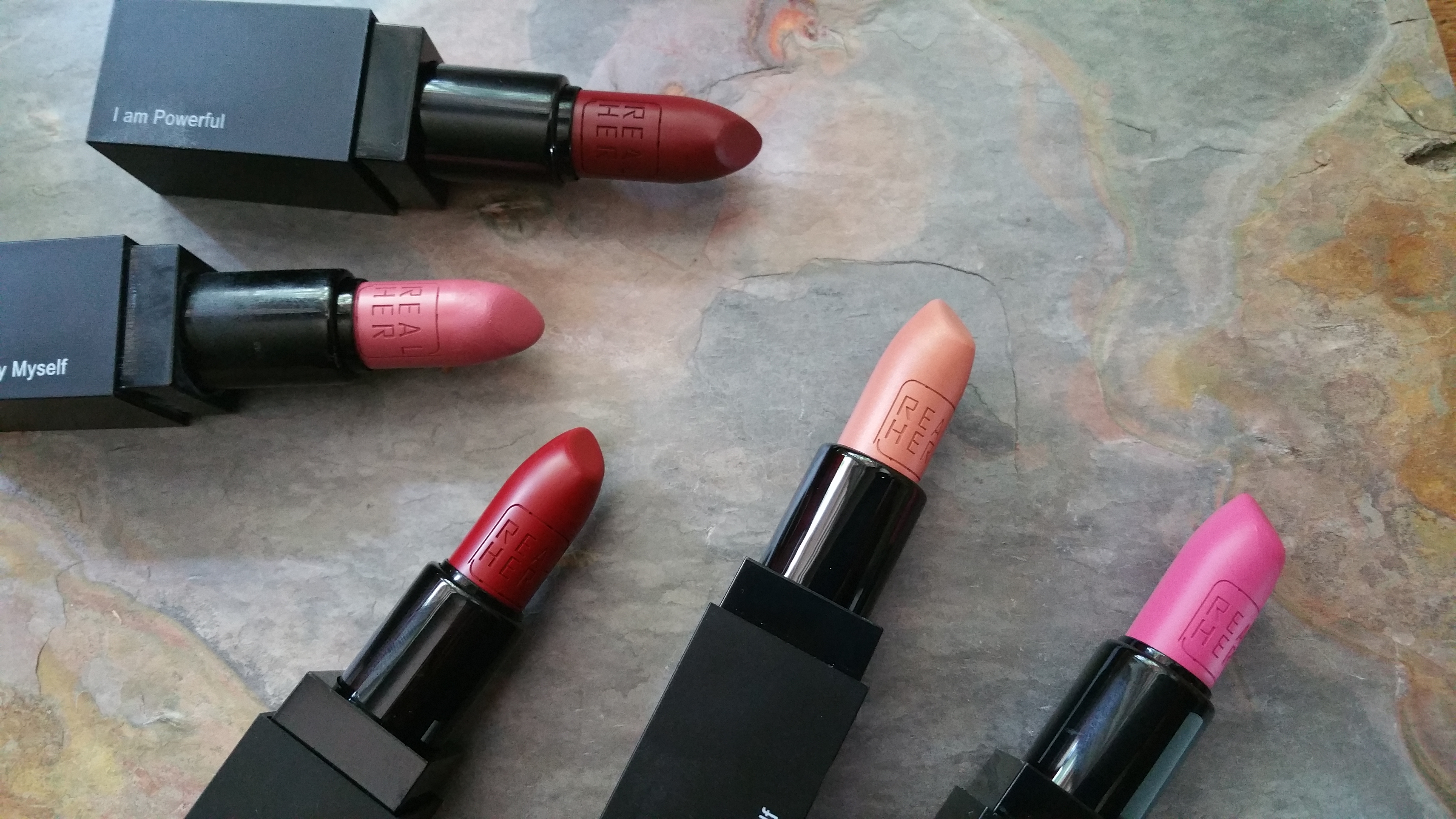 RealHer Lipsticks in I Am Powerful, I Define Beauty Myself, Be Yourself Be RealHer, I Love Myself, and Women Rule the World